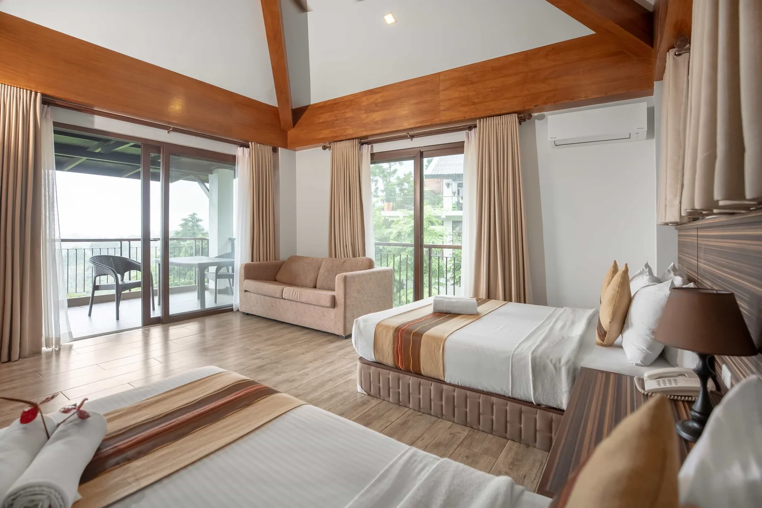 Mist Mountain Resort deluxe room interior with bed and mountain view
